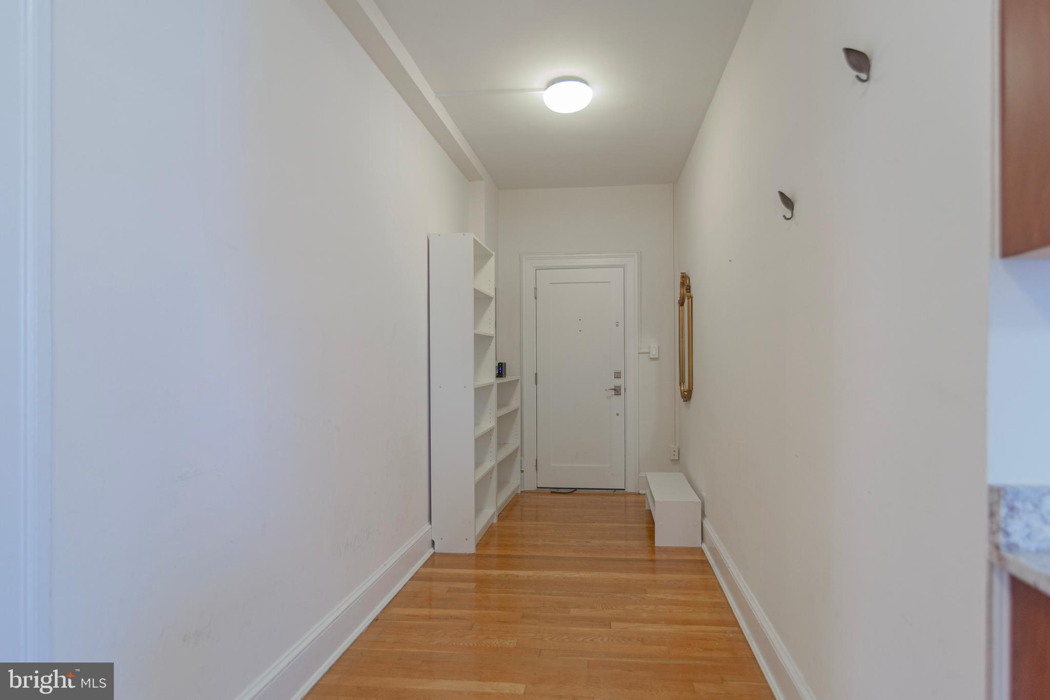 1910 Kalorama Road Northwest, Unit 307 Washington, DC 20009 - Photo 6 of 19 a view of a hallway with wooden floor