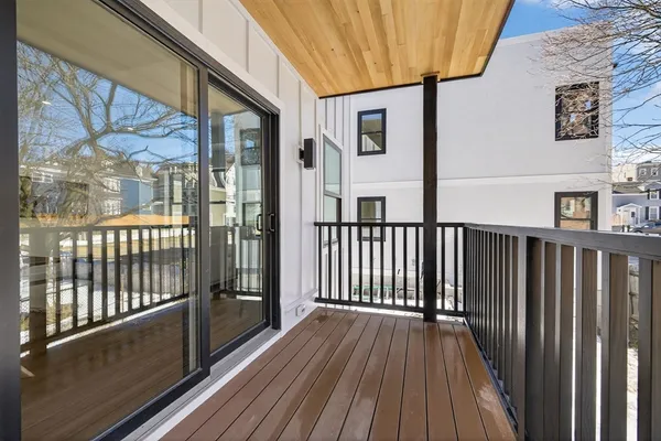 a view of a balcony with wooden floor