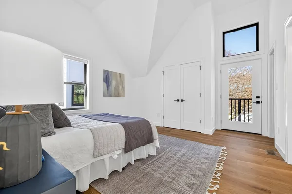 a spacious bedroom with a bed and a window