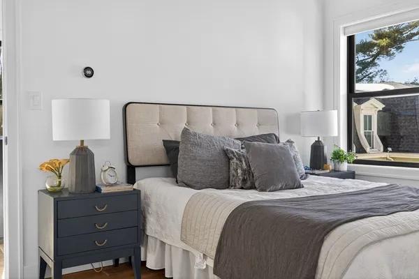 a bed room with a bed window and mirror