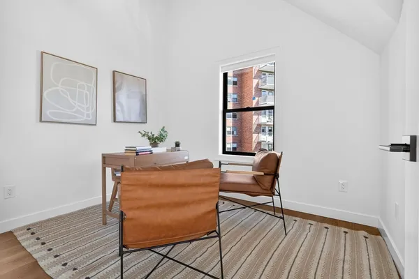 a dining room with furniture and wooden floor