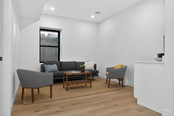 a living room with furniture and a potted plant