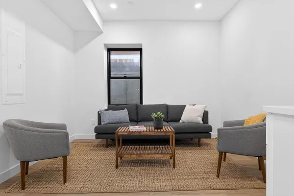 a living room with furniture and a large window