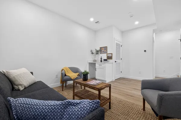 a living room with furniture and a rug