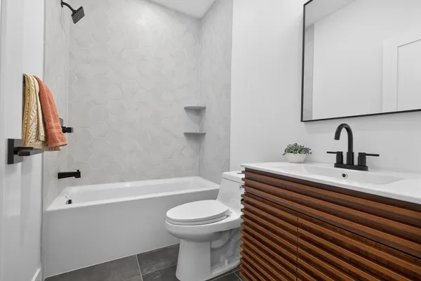 a bathroom with a sink a toilet and a bathtub