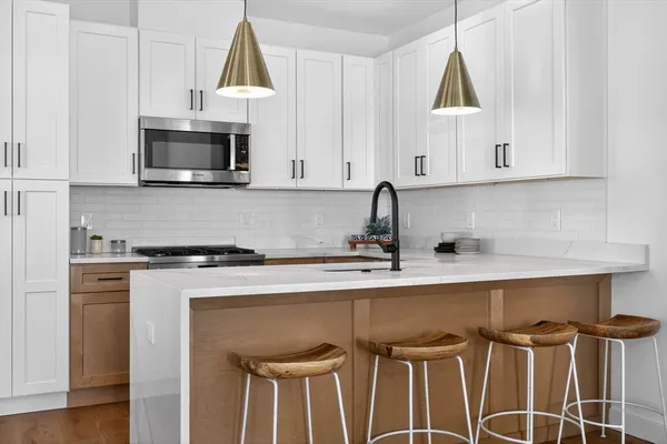 a kitchen with a sink cabinets and window