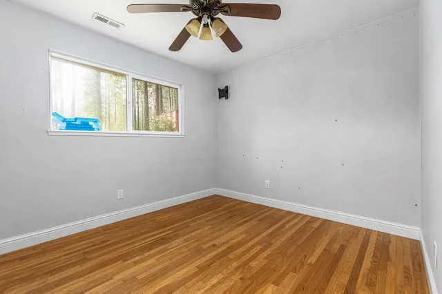 a view of room with hardwood floor and ceiling fan