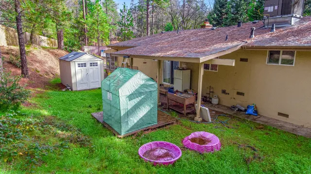 a view of a backyard with a table and chairs