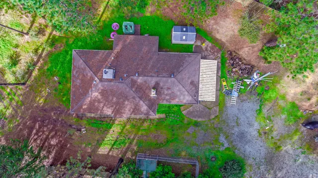 a aerial view of a house with a yard and garden