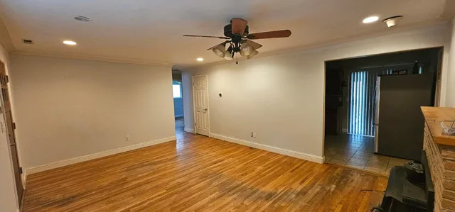 wooden floor in an empty room with a window