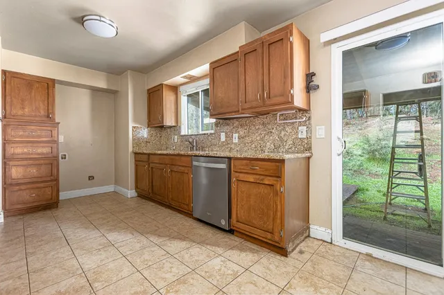 a kitchen with stainless steel appliances granite countertop a refrigerator and a sink