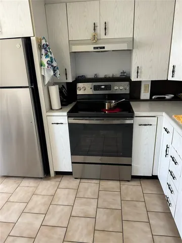 a kitchen with a stove and a refrigerator