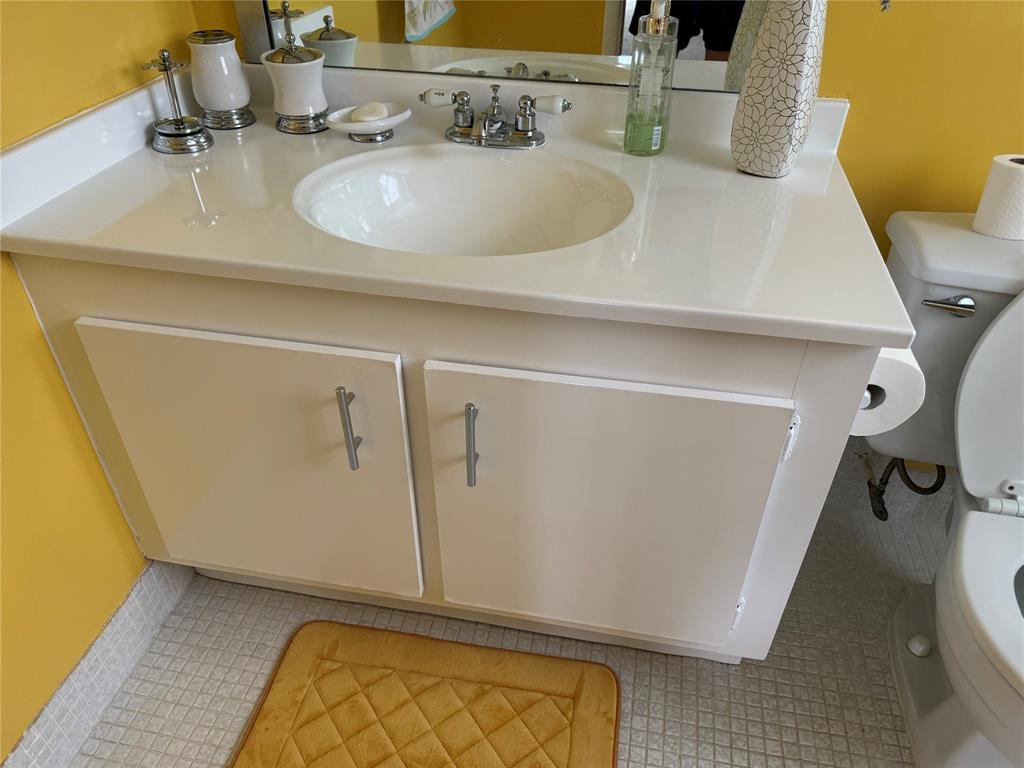 4054 Exeter, Unit C Boca Raton, FL 33434 - Photo 11 of 13 a bathroom with a sink and a mirror