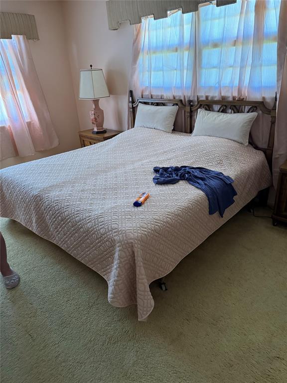 4054 Exeter, Unit C Boca Raton, FL 33434 - Photo 12 of 13 a bed sitting in a bedroom next to a larger window