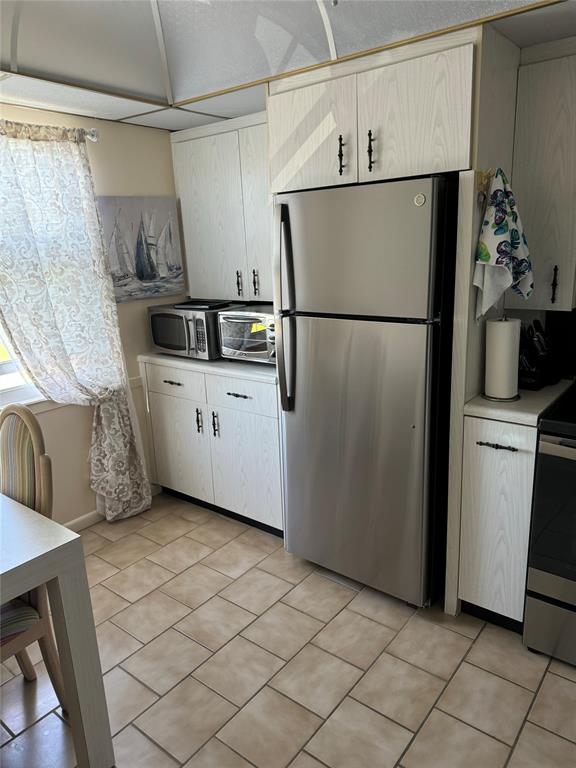 4054 Exeter, Unit C Boca Raton, FL 33434 - Photo 2 of 13 a kitchen with cabinets and stainless steel appliances