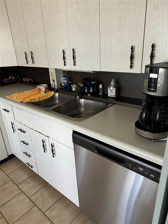 4054 Exeter, Unit C Boca Raton, FL 33434 - Photo 5 of 13 a kitchen with stainless steel appliances granite countertop a sink a stove and white cabinets