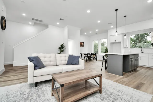 a living room with furniture and kitchen view