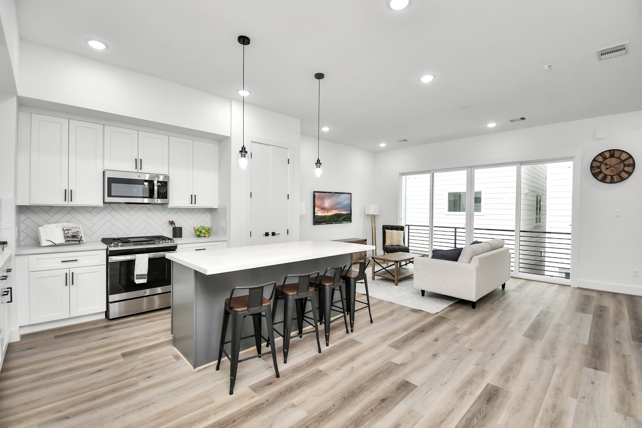 4804 Elysian Street, Unit D Houston, TX 77009 - Photo 14 of 44 a large kitchen with stainless steel appliances kitchen island granite countertop a large island in the center
