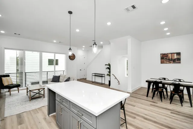 a large kitchen with a table and chairs