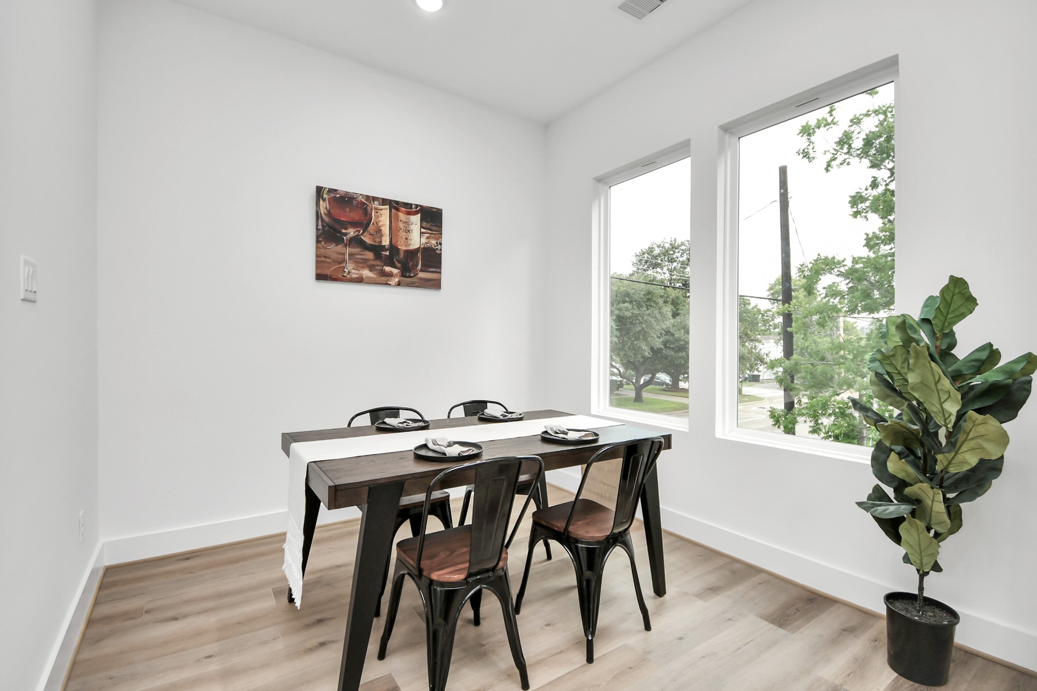 4804 Elysian Street, Unit D Houston, TX 77009 - Photo 20 of 44 a view of a dining room with furniture window and wooden floor