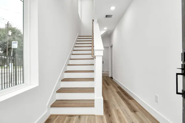 a view of entryway with wooden floor and stairs