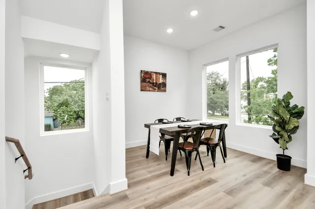 a view of a dining room with furniture window and wooden floor
