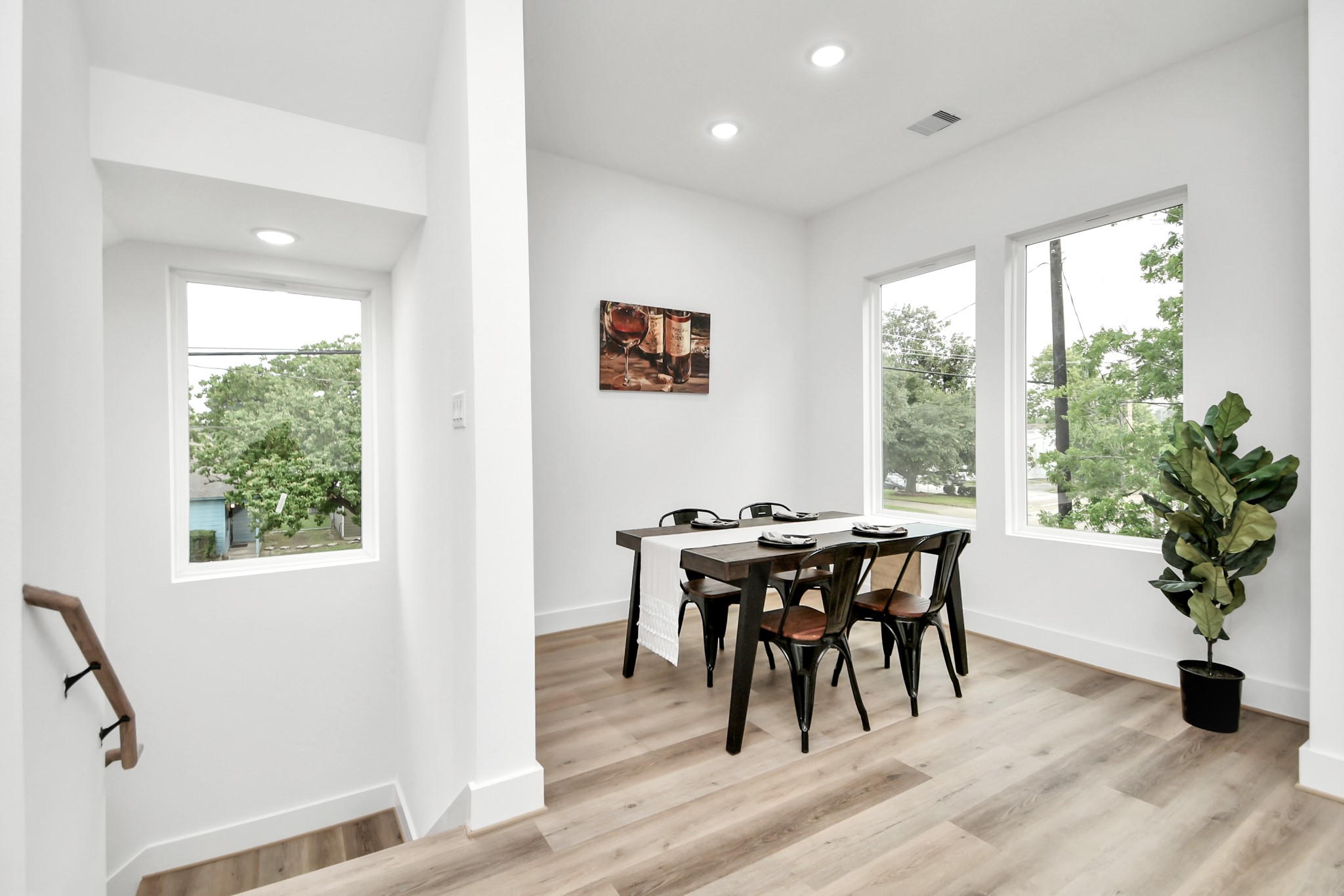 4804 Elysian Street, Unit D Houston, TX 77009 - Photo 22 of 44 a view of a dining room with furniture window and wooden floor