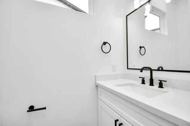 a bathroom with a sink and a mirror