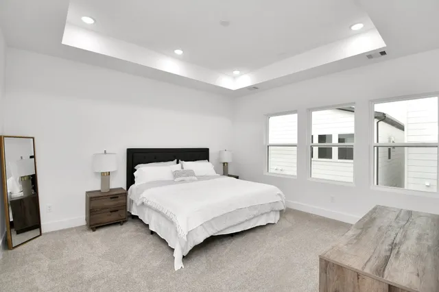 a bedroom with a bed and a large window