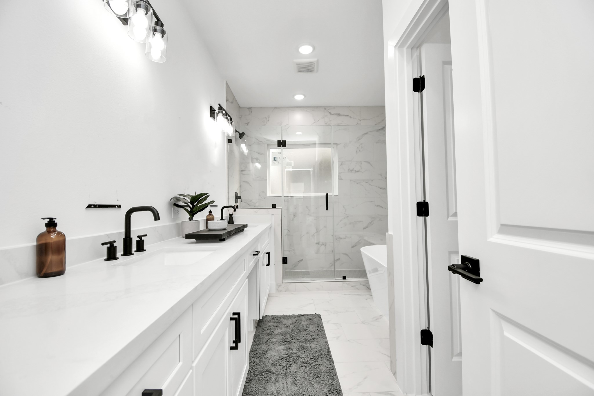 4804 Elysian Street, Unit D Houston, TX 77009 - Photo 29 of 44 a bathroom with a double vanity sink mirror and shower