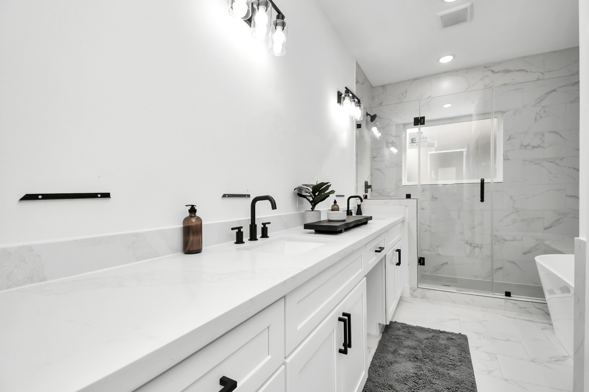 4804 Elysian Street, Unit D Houston, TX 77009 - Photo 30 of 44 a bathroom with a double vanity sink a toilet and shower