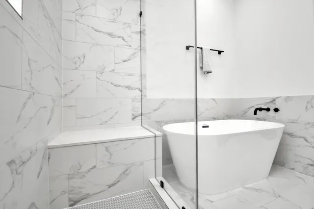 a bathroom with a bathtub and shower