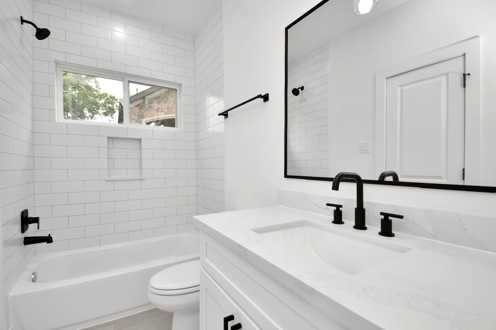 4804 Elysian Street, Unit D Houston, TX 77009 - Photo 37 of 44 a bathroom with a granite countertop sink a toilet and a bathtub