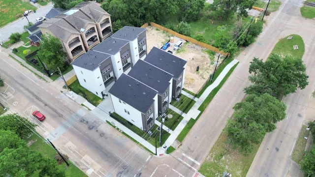 an aerial view of multiple houses with yard