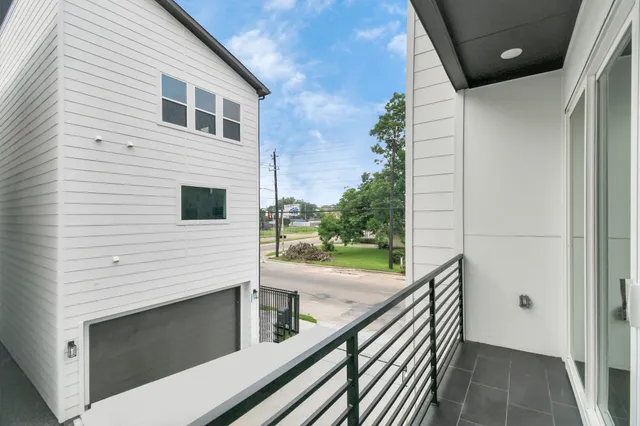 a view of a balcony with wooden floor and fence