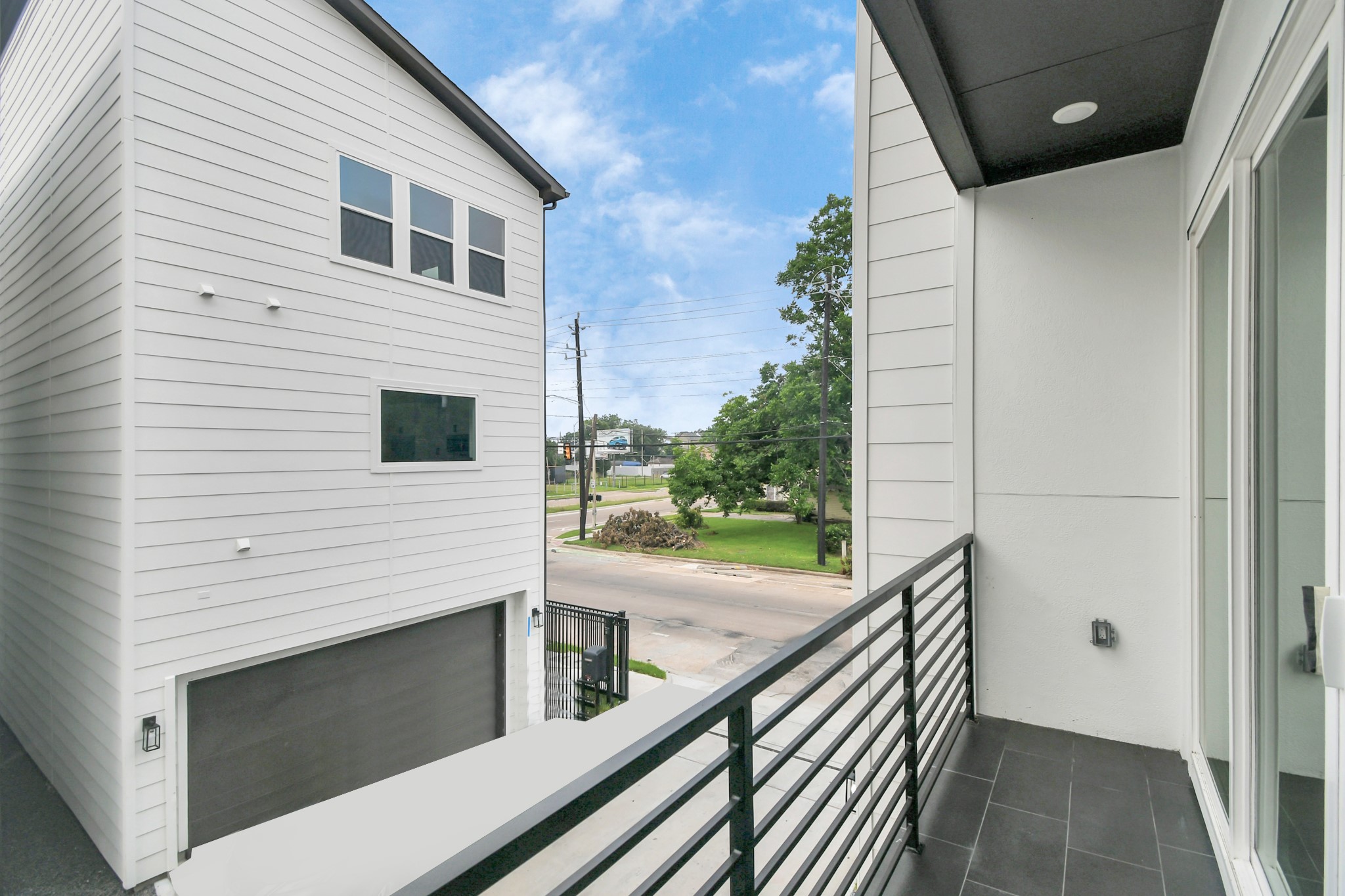 4804 Elysian Street, Unit D Houston, TX 77009 - Photo 6 of 44 a view of a balcony with wooden floor and fence