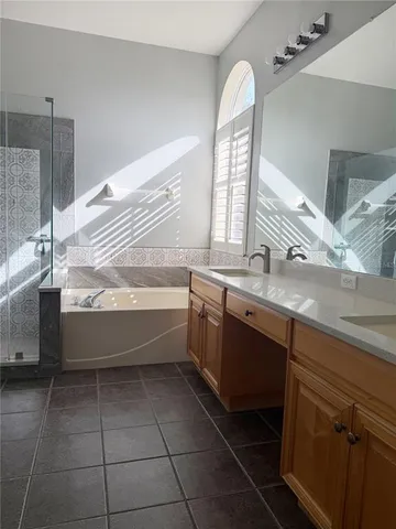 a spacious bathroom with a bathtub sink and mirror