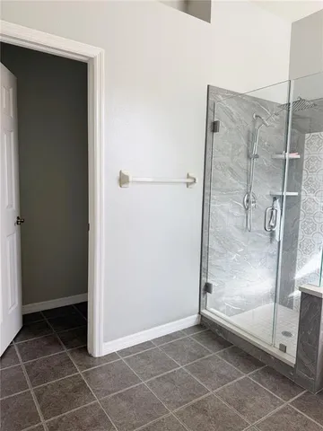 a view of a bathroom with a glass shower door
