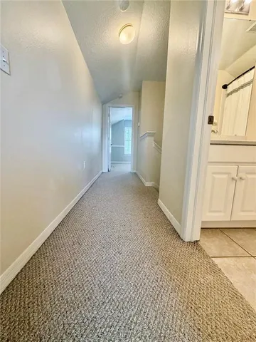a view of a livingroom with wooden floor and cabinet