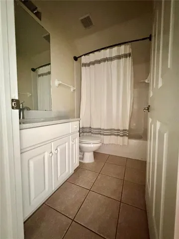 a bathroom with a sink a toilet and a shower