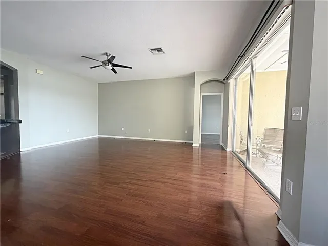 a view of room with window and wooden floor