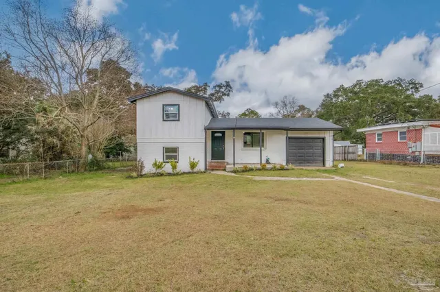 a front view of a house with a garden
