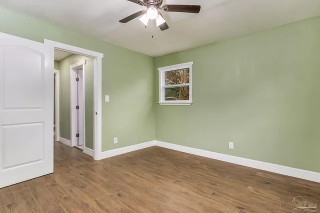 wooden floor in an empty room with a window