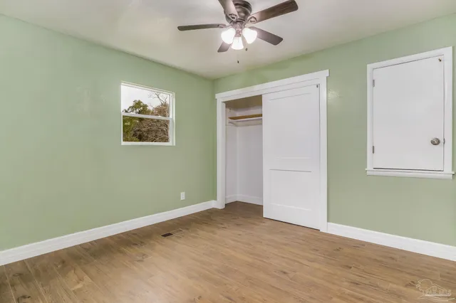 a view of empty room with wooden floor