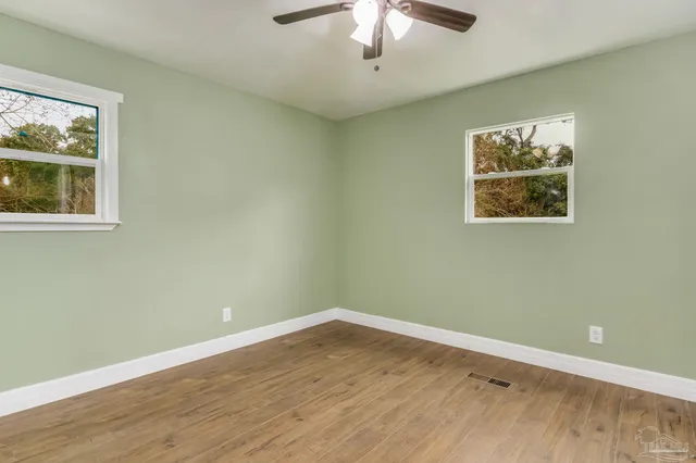 a view of room with window and ceiling fan
