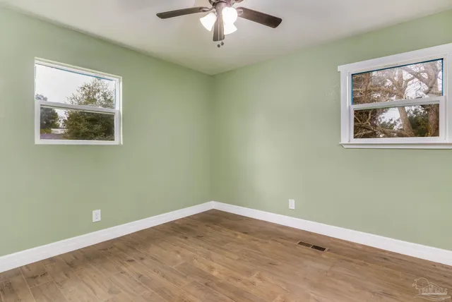 a view of room with window and wooden floor