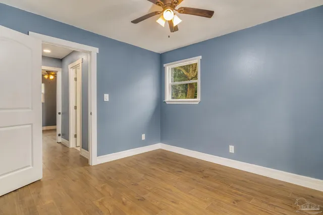 wooden floor in an empty room with a window