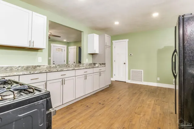 a kitchen with a stove a sink and a refrigerator