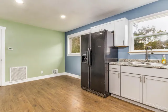 a kitchen with stainless steel appliances granite countertop a refrigerator and a sink