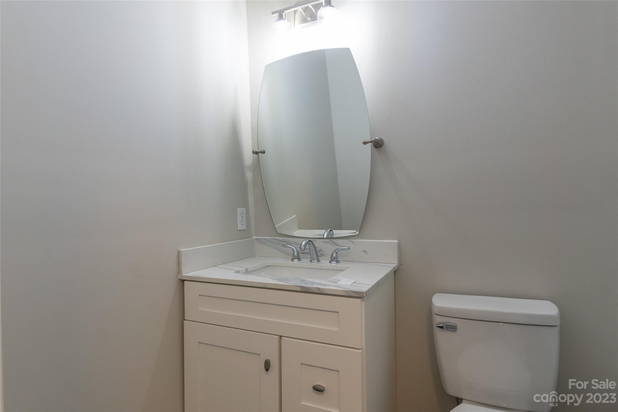 1531 Ruth Street, Unit 2 Lancaster, SC 29720 - Photo 12 of 33 a bathroom with a toilet sink and mirror